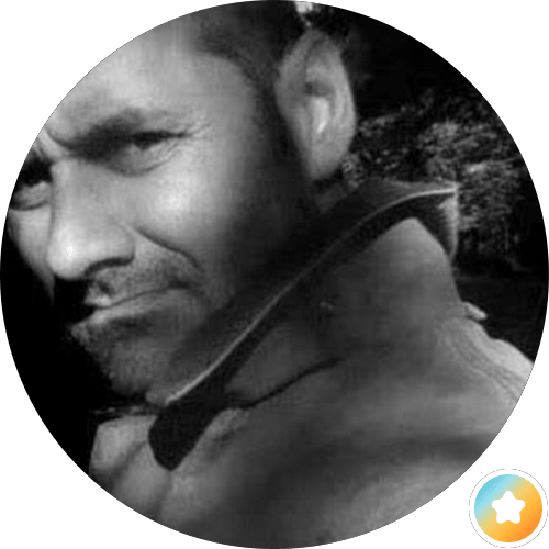 A man gazes directly at the camera in a striking black and white photograph.